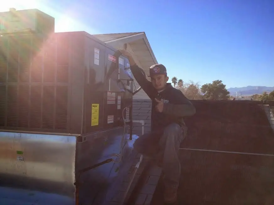 HVAC technician performing HVAC Inspection on a rooftop unit in Carroll